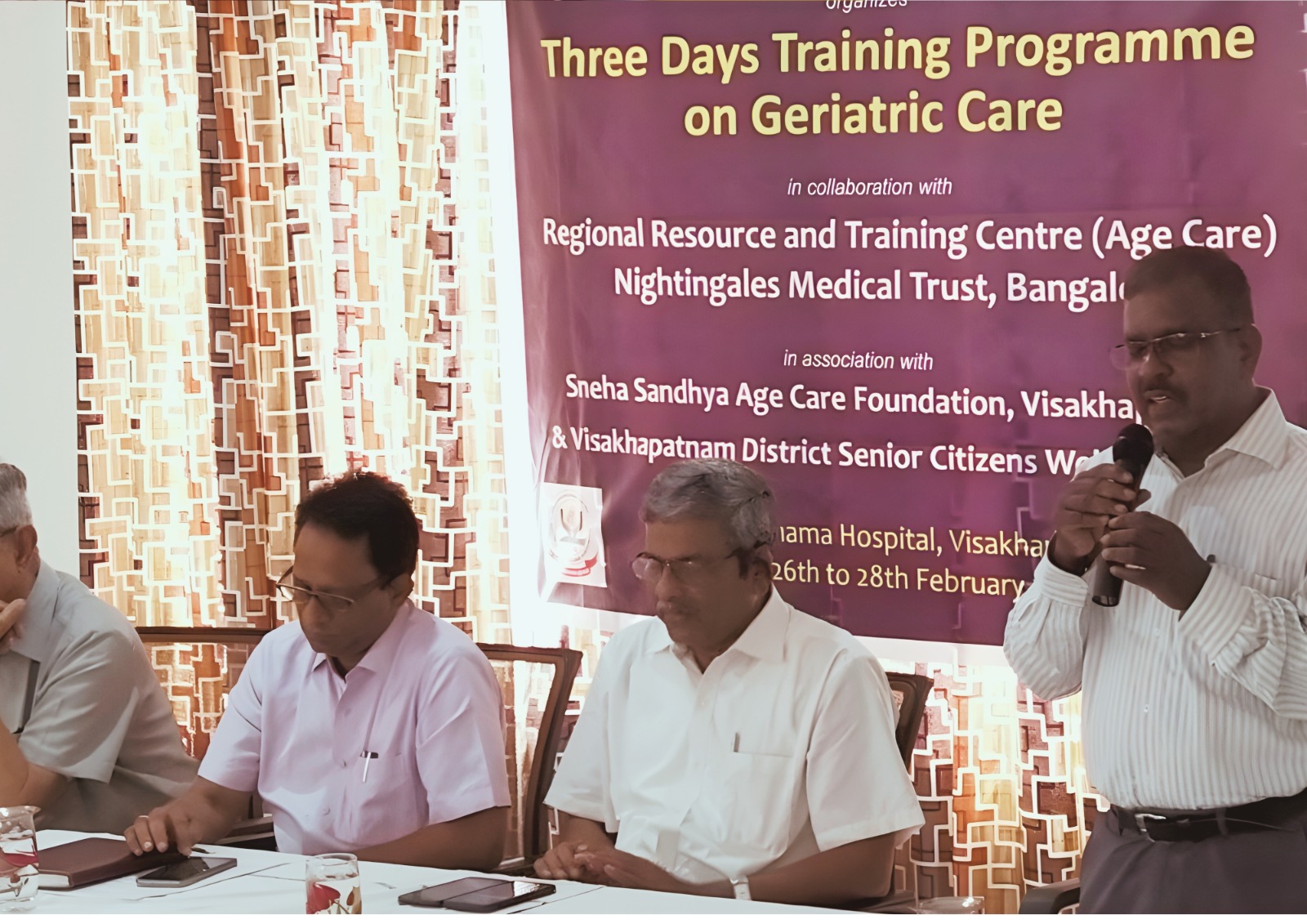 A person speaking at a podium during a conference.
